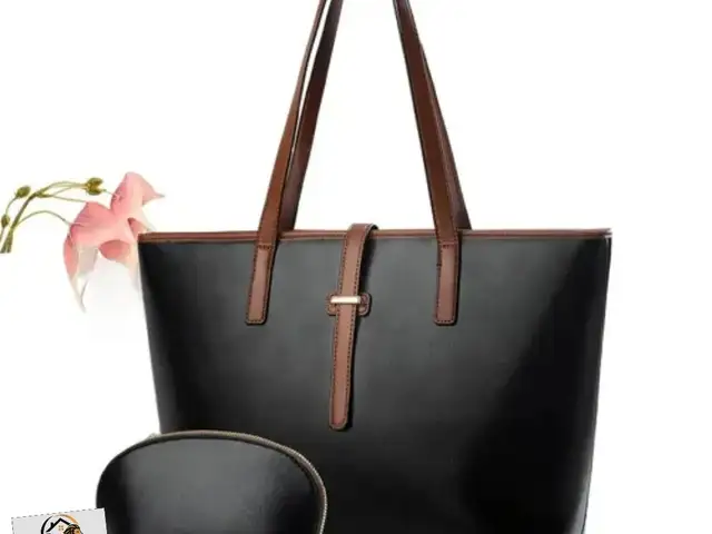 large black PU leather tote bag with brown straps and a matching small pouch., Couva