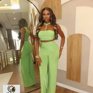 two-piece outfit featuring a halter crop top with a gold chain detail and high-w, Couva